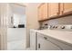 Convenient laundry area equipped with a washer, dryer, and ample cabinet space at 1816 Eagle Mesa Ave, Henderson, NV 89012