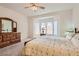 Comfortable carpeted bedroom featuring a bay window and carpeted floors with a dresser at 1816 Eagle Mesa Ave, Henderson, NV 89012
