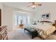 Comfortable bedroom with a bay window, wooden dresser and carpet at 1816 Eagle Mesa Ave, Henderson, NV 89012