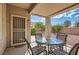 Covered patio perfect for outdoor dining with a table, chairs, and a security door at 1816 Eagle Mesa Ave, Henderson, NV 89012