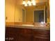 Bathroom boasts warm colors, vanity with marble-look countertop, and a large mirror at 1851 Hillpointe Rd # 1711, Henderson, NV 89074
