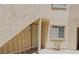 Inviting condo featuring a textured exterior with door, window, and staircase at 1851 Hillpointe Rd # 1711, Henderson, NV 89074