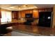 Well-equipped kitchen featuring granite countertops, tile backsplash, and dark cabinets at 1851 Hillpointe Rd # 1711, Henderson, NV 89074