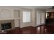 Spacious room with fireplace, wood floors, and access to a kitchen through glass doors at 1851 Hillpointe Rd # 1711, Henderson, NV 89074