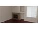 Bright room with fireplace, hardwood floors, and natural light from the window at 1851 Hillpointe Rd # 1711, Henderson, NV 89074