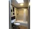 Cozy bathroom with shower-tub combo and modern fixtures under a bright skylight at 2217 Santa Ynez Dr, Las Vegas, NV 89104