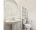 Bathroom features a pedestal sink, toilet, and built-in shelving unit at 2343 Teatro Ave, Henderson, NV 89044