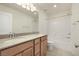 A well-lit bathroom with a double sink vanity, shower-tub combo, and modern fixtures at 2343 Teatro Ave, Henderson, NV 89044