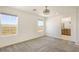 A bright bedroom with carpet flooring, ceiling fan, and windows providing natural light and views at 2343 Teatro Ave, Henderson, NV 89044