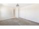 A carpeted bedroom with a modern ceiling fan, closet, and an adjacent bathroom at 2343 Teatro Ave, Henderson, NV 89044