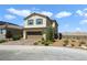 Two-story home featuring a desert landscape, brown garage door and blue shutters at 2343 Teatro Ave, Henderson, NV 89044