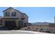 Charming two-story home with stucco siding, a two-car garage, and beautiful desert landscaping in front at 2343 Teatro Ave, Henderson, NV 89044