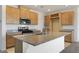 Kitchen with stainless steel appliances, granite countertops, a kitchen island with sink, and light wood cabinetry at 2343 Teatro Ave, Henderson, NV 89044