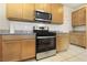 Kitchen features stainless steel appliances, light wood cabinets, granite countertops, and tile flooring at 2343 Teatro Ave, Henderson, NV 89044