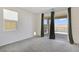Carpeted room with large sliding glass doors to a patio, a window, and neutral walls at 2343 Teatro Ave, Henderson, NV 89044