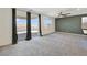 Spacious living room with carpet, sliding glass doors to the patio, and a ceiling fan at 2343 Teatro Ave, Henderson, NV 89044