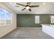 Large living room with carpet, an accent wall, plenty of windows, and a ceiling fan at 2343 Teatro Ave, Henderson, NV 89044