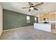 Open living room featuring neutral carpet, a large window, an adjacent kitchen, and natural light at 2343 Teatro Ave, Henderson, NV 89044