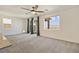 Spacious living room features neutral carpet, ceiling fan, sliding glass doors, and bright natural light at 2343 Teatro Ave, Henderson, NV 89044