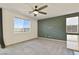 Bright living room with carpet, a large window, a unique textured wall, and a ceiling fan at 2343 Teatro Ave, Henderson, NV 89044