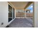 Covered patio with stone tile flooring, a partial view of the backyard, and access to the home's interior at 2343 Teatro Ave, Henderson, NV 89044