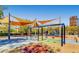 Community playground with swings and play equipment shaded by awnings at 2343 Teatro Ave, Henderson, NV 89044