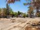 Open backyard featuring a shed, desert landscaping, and mature trees, offering potential for customization at 2645 Lindell Rd, Las Vegas, NV 89146