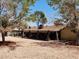 Lush backyard featuring desert landscaping, mature trees, and a covered patio area, perfect for entertaining at 2645 Lindell Rd, Las Vegas, NV 89146