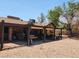 Backyard featuring a shaded patio, gravel landscaping, and mature trees, perfect for outdoor living at 2645 Lindell Rd, Las Vegas, NV 89146