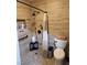 Modern bathroom with tiled walls, matte black fixtures, and convenient storage shelves for toiletries at 2645 Lindell Rd, Las Vegas, NV 89146