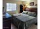 Comfortable bedroom featuring a plush bed with quilted bedding, complemented by wooden furniture at 2645 Lindell Rd, Las Vegas, NV 89146