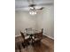 Cozy dining area featuring a glass top table, seating for four and a modern ceiling fan at 2645 Lindell Rd, Las Vegas, NV 89146