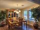 Formal dining room featuring a stylish chandelier, natural lighting and built in hutch at 2645 Lindell Rd, Las Vegas, NV 89146