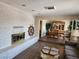 Inviting living room with a brick fireplace, wood flooring, and an open dining area at 2645 Lindell Rd, Las Vegas, NV 89146