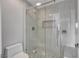 Modern bathroom features a glass shower with gray and white marble tile and a built-in niche at 27 E Agate Ave # 505, Las Vegas, NV 89123