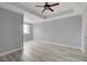 Spacious bedroom with modern gray walls, wood flooring, a ceiling fan, and large windows at 27 E Agate Ave # 505, Las Vegas, NV 89123
