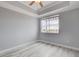 Bedroom with gray walls, wood flooring, tray ceiling, ceiling fan, and large windows at 27 E Agate Ave # 505, Las Vegas, NV 89123