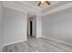 Bedroom with gray walls, wood flooring, tray ceiling, ceiling fan, and sliding closet doors at 27 E Agate Ave # 505, Las Vegas, NV 89123