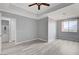 Bedroom with gray walls, tray ceiling, wood flooring, large windows, and interior design elements at 27 E Agate Ave # 505, Las Vegas, NV 89123