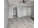 Neutral bedroom with gray walls, wood flooring, tray ceiling, and closet entrance at 27 E Agate Ave # 505, Las Vegas, NV 89123