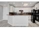 Updated kitchen with white cabinets, granite countertops, and black appliances at 27 E Agate Ave # 505, Las Vegas, NV 89123