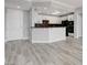 Open concept kitchen with white cabinets, granite countertops and black appliances at 27 E Agate Ave # 505, Las Vegas, NV 89123