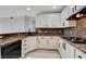 Modern kitchen with white cabinets, granite countertops, and stainless steel appliances at 27 E Agate Ave # 505, Las Vegas, NV 89123