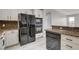 This kitchen features granite countertops, stainless appliances, and modern white cabinets at 27 E Agate Ave # 505, Las Vegas, NV 89123