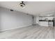 Bright living room with hardwood floors, with view of the kitchen and modern lighting at 27 E Agate Ave # 505, Las Vegas, NV 89123