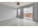 Bright living room featuring a private balcony, a modern light fixture, and neutral wall paint at 27 E Agate Ave # 505, Las Vegas, NV 89123