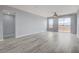 Spacious living room with grey wood-look floors and balcony access at 27 E Agate Ave # 505, Las Vegas, NV 89123