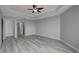 Spacious bedroom features tray ceiling with fan, and wood look floors at 27 E Agate Ave # 505, Las Vegas, NV 89123