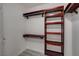 Walk-in closet with wooden shelving and hanging racks for organization at 27 E Agate Ave # 505, Las Vegas, NV 89123