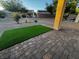 A brick paver backyard with synthetic grass at 2704 Willow Wren Dr, North Las Vegas, NV 89084